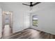 Bedroom featuring wood-look floors, ceiling fan, closet, and natural light at 4715 Kemble Ct, Tampa, FL 33624