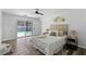 Bright bedroom with wood-look floors, and sliding glass doors leading to backyard at 4715 Kemble Ct, Tampa, FL 33624