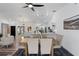 Open-concept dining area with a wooden table, upholstered chairs, flowing into the living space at 4715 Kemble Ct, Tampa, FL 33624