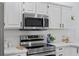 Close-up of kitchen with stainless steel appliances and white countertops at 4715 Kemble Ct, Tampa, FL 33624