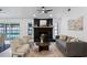 Beautiful living room with contemporary furnishings, sleek ceiling fan, and a striking stone fireplace at 4715 Kemble Ct, Tampa, FL 33624