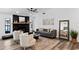 Bright living area showcasing modern furniture, a ceiling fan, sleek flooring, and a charming stone fireplace at 4715 Kemble Ct, Tampa, FL 33624