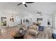 Spacious and airy open-plan living area with modern furnishings, a fireplace, and direct access to kitchen and dining at 4715 Kemble Ct, Tampa, FL 33624
