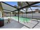 A screened-in pool area with a turquoise colored pool and a patio area with room for seating at 4715 Kemble Ct, Tampa, FL 33624
