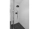 Modern shower with black fixtures, subway tile, and hexagonal tile floor at 4715 Kemble Ct, Tampa, FL 33624