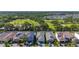 Aerial view of homes in a beautiful community with scenic green spaces, a pond, and lush landscaping at 5415 Los Robles Ct, Palmetto, FL 34221