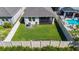 A pristine backyard boasts lush green grass, a privacy fence, and a screened-in lanai for outdoor enjoyment at 5415 Los Robles Ct, Palmetto, FL 34221