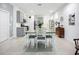 Charming dining area featuring an open layout to the kitchen and grey cabinets, perfect for modern living at 5415 Los Robles Ct, Palmetto, FL 34221