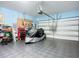 Spacious garage with diamond plate flooring and ample storage for vehicles and tools at 5415 Los Robles Ct, Palmetto, FL 34221