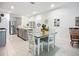 Open kitchen concept with a large island, stainless steel appliances, and a casual dining area at 5415 Los Robles Ct, Palmetto, FL 34221