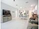 Open-concept living room and dining area feature neutral decor, tile floors and plenty of natural light at 5415 Los Robles Ct, Palmetto, FL 34221