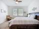 The main bedroom features two large windows, a ceiling fan, and a sitting area with comfortable furniture at 5415 Los Robles Ct, Palmetto, FL 34221