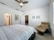 The main bedroom features neutral decor, a ceiling fan, and doorway leading to the bathroom at 5415 Los Robles Ct, Palmetto, FL 34221