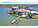 Stunning waterfront home with private dock, pool, and lush landscaping on a peninsula, showcasing luxury living at 5630 Bayview Dr, Seminole, FL 33772