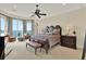 Serene main bedroom with water views, a seating area, and a ceiling fan at 5630 Bayview Dr, Seminole, FL 33772