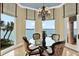 Bright breakfast nook with waterfront views, featuring a cozy round table and elegant chandelier at 5630 Bayview Dr, Seminole, FL 33772