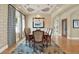Refined dining room features coffered ceilings, elegant lighting, and beautiful patterned wallpaper at 5630 Bayview Dr, Seminole, FL 33772