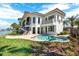 Luxury waterfront home with a pool, lush landscaping, and a charming backyard at 5630 Bayview Dr, Seminole, FL 33772