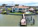 Expansive waterfront estate featuring a private dock, refreshing pool, and beautifully manicured lawn at 5630 Bayview Dr, Seminole, FL 33772