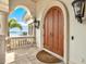 Grand arched front door with stone accents and a view of the water at 5630 Bayview Dr, Seminole, FL 33772