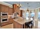 Gourmet kitchen with custom cabinets, granite countertops, and modern appliances, overlooking stunning waterfront views at 5630 Bayview Dr, Seminole, FL 33772