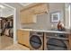 Well-equipped laundry room featuring modern appliances, granite countertops, and ample storage at 5630 Bayview Dr, Seminole, FL 33772