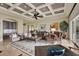 Open-concept living space with coffered ceiling, elegant seating, and seamless flow to dining and kitchen at 5630 Bayview Dr, Seminole, FL 33772