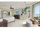 Bright main bedroom featuring a decorative wall display, comfortable seating, and an ocean view at 5630 Bayview Dr, Seminole, FL 33772