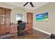Home office with custom built-in cabinetry, desk, and an ocean view displayed on the flat screen TV at 5630 Bayview Dr, Seminole, FL 33772