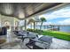 Spacious outdoor patio with lounge chairs, water views, and access to a private dock at 5630 Bayview Dr, Seminole, FL 33772
