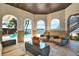 Covered patio area with outdoor seating overlooking the pool and waterfront at 5630 Bayview Dr, Seminole, FL 33772