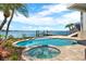 Beautiful pool, jacuzzi, and dock, set against a scenic waterfront backdrop at 5630 Bayview Dr, Seminole, FL 33772