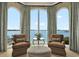 Cozy sitting area with water views, comfortable chairs, and elegant drapery at 5630 Bayview Dr, Seminole, FL 33772