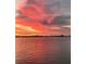 Striking sunset view over the water, casting vibrant colors across the sky and reflecting on the horizon at 5630 Bayview Dr, Seminole, FL 33772