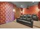 Home theater with red wallpaper, comfortable seating, and a projector at 5630 Bayview Dr, Seminole, FL 33772