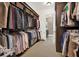 Spacious walk-in closet with custom shelving and rods for ample storage and organization at 5630 Bayview Dr, Seminole, FL 33772