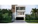 Modern three-story home with a balcony, wood accents, and a two-car garage at 664 Geneva Pl, Tampa, FL 33606