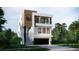 Contemporary three-story house with a balcony, wood details, and a two-car garage at 664 Geneva Pl, Tampa, FL 33606