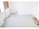 Enclosed sunroom with white walls and gray floor perfect for home projects at 7435 Hollyridge Dr, New Port Richey, FL 34653