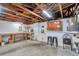 Unfinished basement with exposed beams, water heater, and work area at 7824 Blackstone Dr, Port Richey, FL 34668