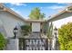 Welcoming front entrance with a decorative gate, manicured bushes, and elegant lighting at 7824 Blackstone Dr, Port Richey, FL 34668