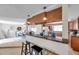 Stylish kitchen featuring a breakfast bar with seating, open to the dining area and modern appliances at 7824 Blackstone Dr, Port Richey, FL 34668