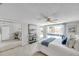 Bright bedroom features a ceiling fan, closet, neutral paint and access to the backyard patio at 7824 Blackstone Dr, Port Richey, FL 34668