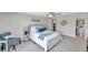 Spacious main bedroom with neutral paint, ceiling fan, carpet floors and ensuite bathroom at 7824 Blackstone Dr, Port Richey, FL 34668