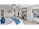 Comfortable bedroom with a ceiling fan, neutral paint and ensuite bathroom with plenty of closet space at 7824 Blackstone Dr, Port Richey, FL 34668