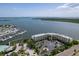 Stunning aerial view showcases waterfront condo, boat docks, lush landscaping and convenient parking areas at 8800 Bay Pines Blvd # 318, St Petersburg, FL 33709
