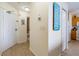 Hallway displaying wall decor and tile flooring, leading to a bathroom and kitchen at 8800 Bay Pines Blvd # 318, St Petersburg, FL 33709