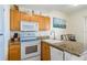 Well-lit kitchen with granite countertops, modern appliances, and ample cabinet space, enhancing functionality at 8800 Bay Pines Blvd # 318, St Petersburg, FL 33709