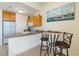 Efficient kitchen with granite countertops, a casual dining area and ample cabinet space for storage at 8800 Bay Pines Blvd # 318, St Petersburg, FL 33709