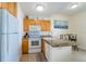 Efficient kitchen featuring granite countertops, white appliances, and adjacent dining space at 8800 Bay Pines Blvd # 318, St Petersburg, FL 33709